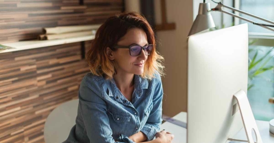 A woman reading her computer screen.