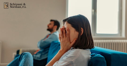 divorcing couple sitting on the couch stressed