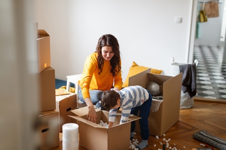 mother and son packing up moving boxes