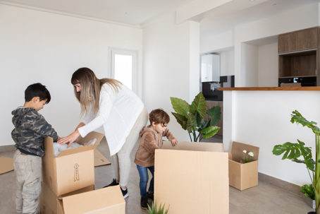 mother and children packing moving boxes