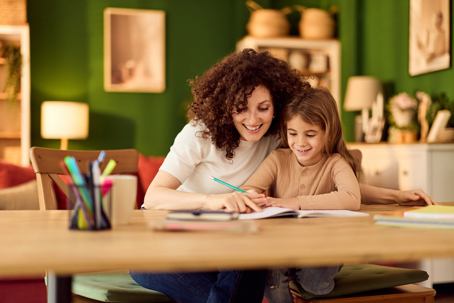 mother helping daughter with homework